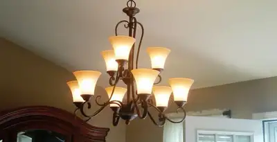 Classic ceiling chandelier installation with warm lighting in Columbia, MO