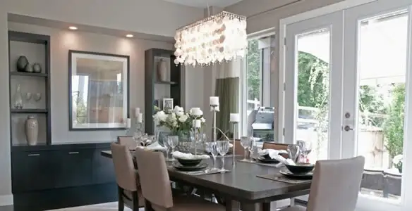 Elegant dining room chandelier installation above table in Columbia, MO
