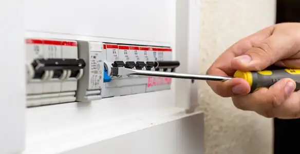 electrical panel upgrade service showing technician adjusting circuit breakers during system upgrade in Columbia, MO