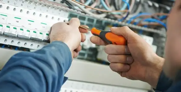 electrical service showing licensed electrician performing electrical panel maintenance and adjustments in Columbia, MO