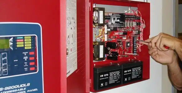 fire alarm installation service showing technician configuring fire alarm control panel in Columbia, MO