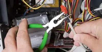 Licensed electrical contractor performing electrical repair with tools in Jamestown, MO