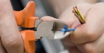 professional electrical services showing precise wire cutting by licensed electricians in Columbia, MO