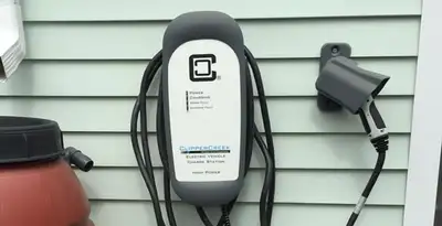 Outdoor electric vehicle charger installation on residential wall in Columbia, MO