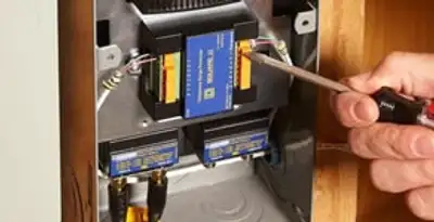 Whole home surge protection device being installed by a licensed electrician to protect electrical systems in Columbia, MO